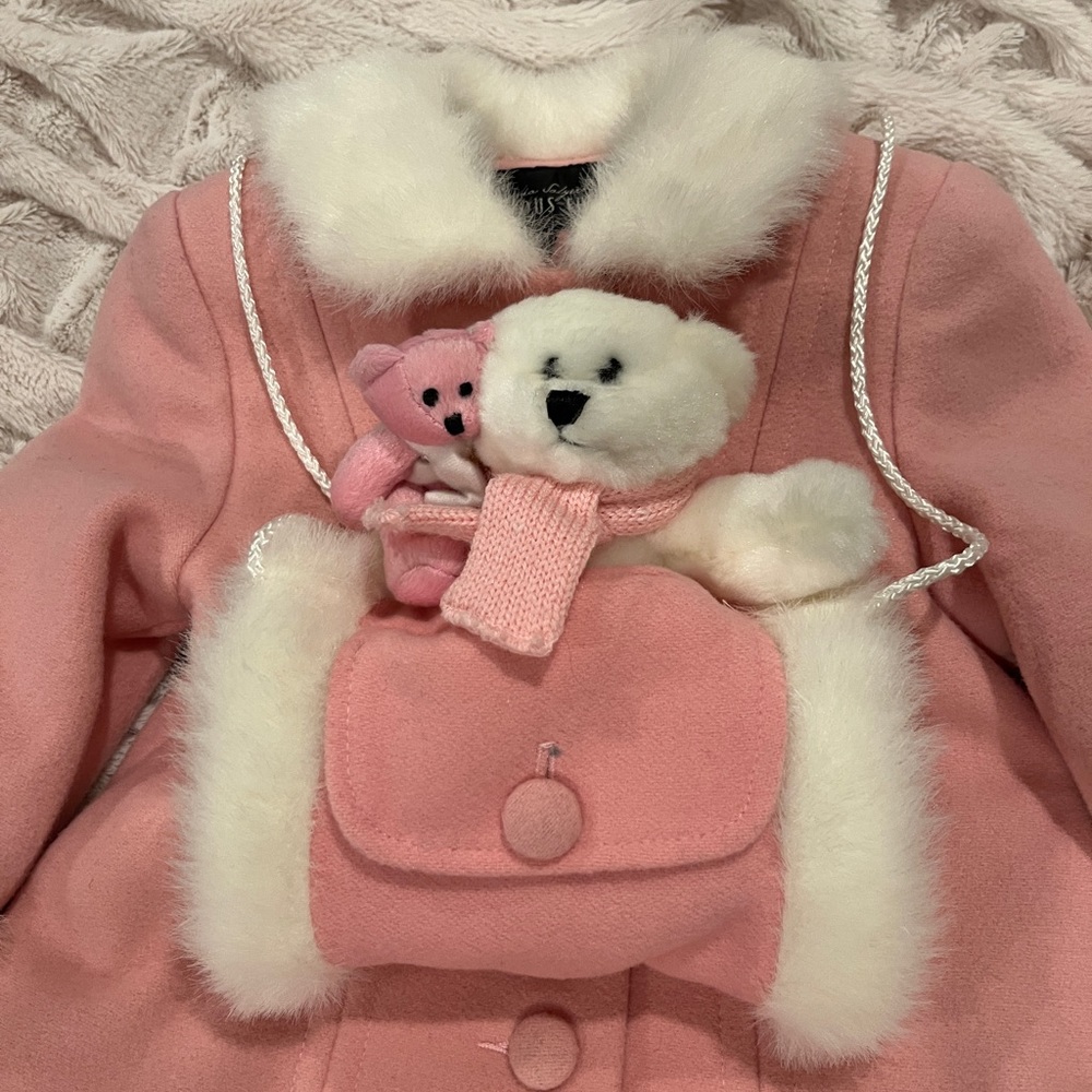 Pink Faux Fur coat. Elegant coat features a hand warmer plush accessory.